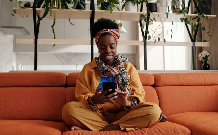 A woman at home checking her phone